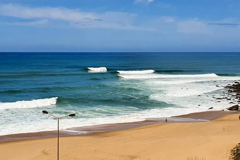 Waves breaking left and right at Praia da Calada