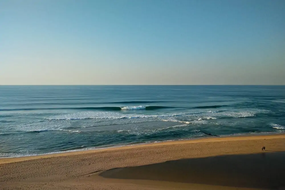 Few surfers enjoying perfect conditions at Praia de Santa Rita