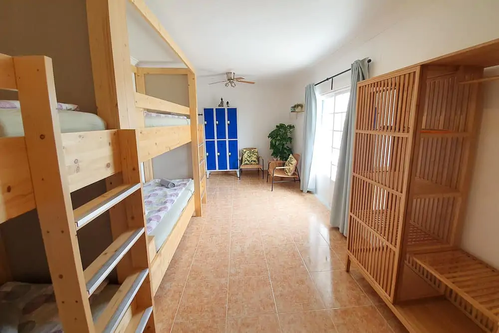 Spacious shared room with bunk beds, safe, closet, chairs and access to the balcony